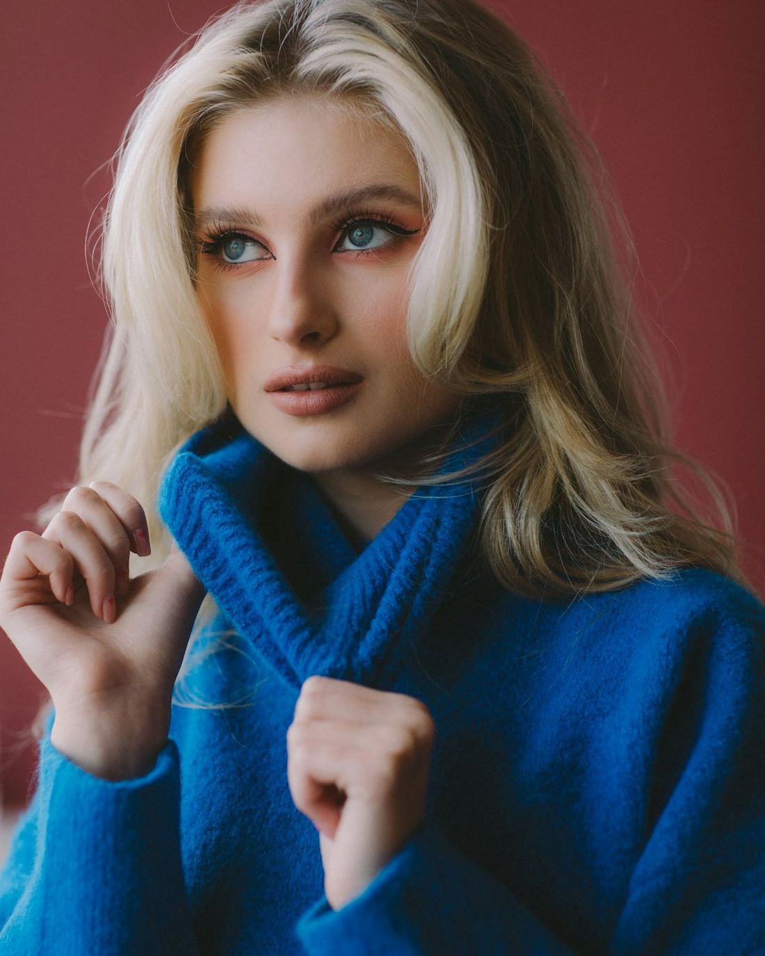 Model in a blue knit sweater